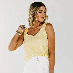 Adorable yellow pom pom tank from Blu Pepper